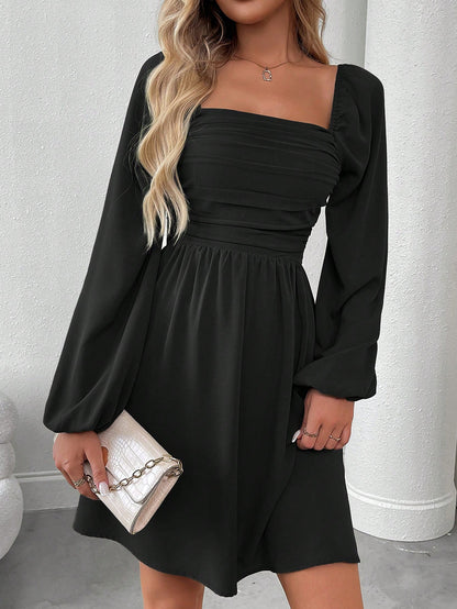 Solid color dress with lantern sleeves and smocked waist.