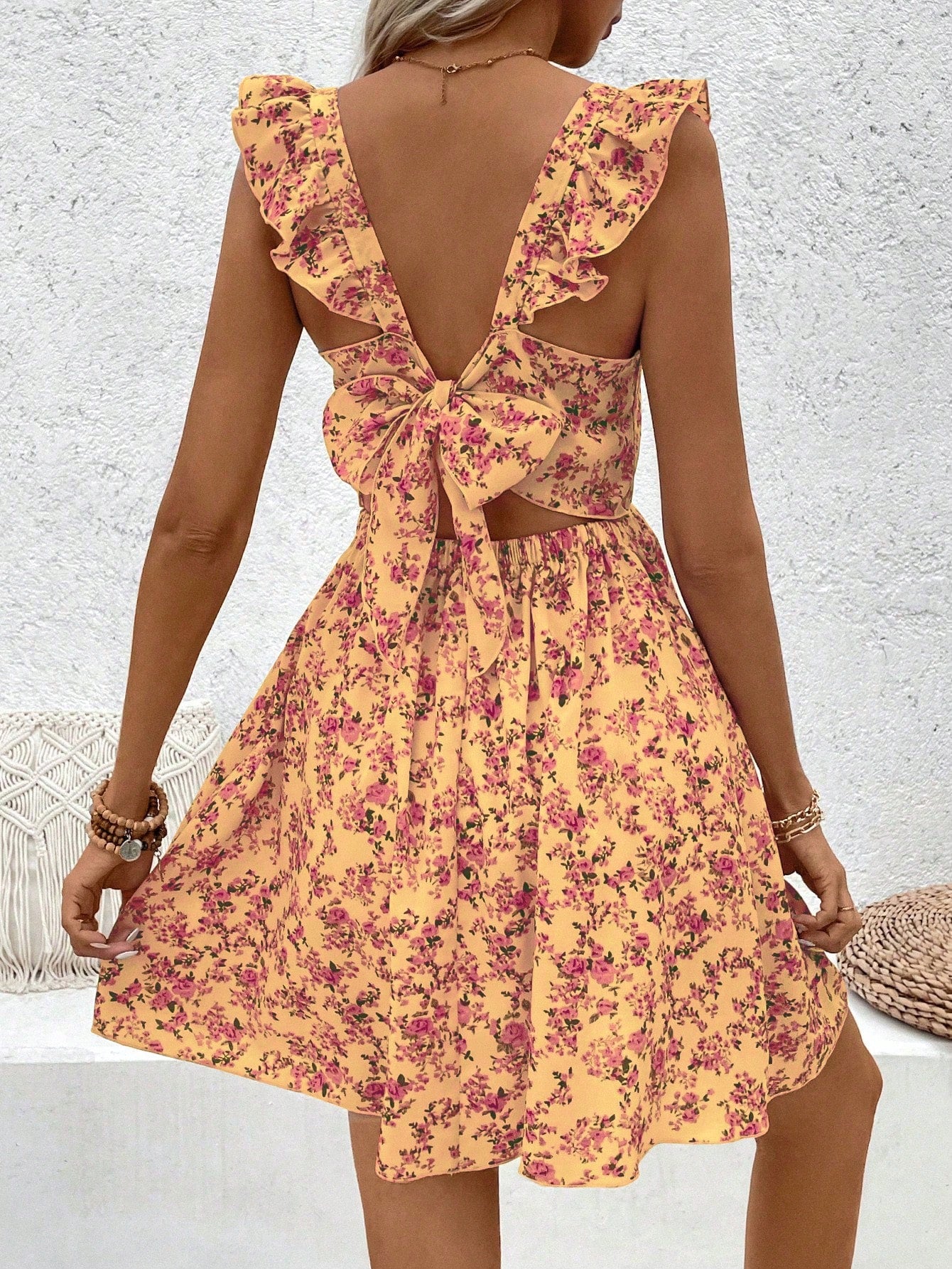 Floral printed dress with hollow-out hem and ruffle trim.