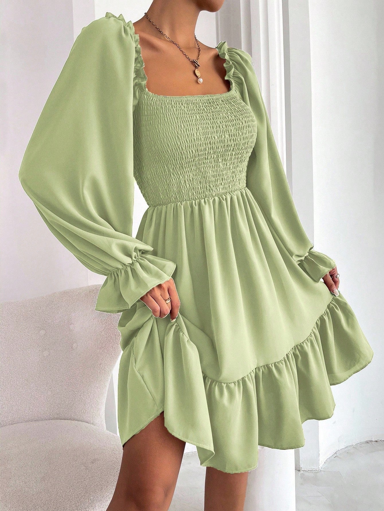 Square-neck dress with shirred bodice, flounce sleeves, and ruffle hem.