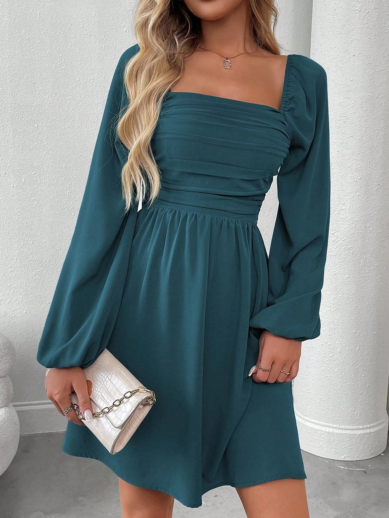 Solid color dress with lantern sleeves and smocked waist.